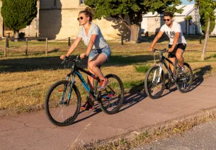Cyclists passing in front of the Saint-Louis tower in Port-Saint-Louis-du-Rhône